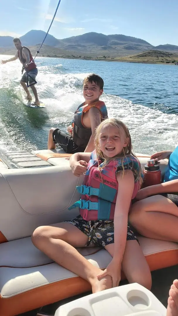 A group of people on a boat in the water.