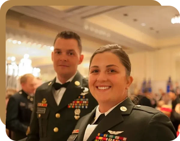 Two people in military uniforms posing for a picture.