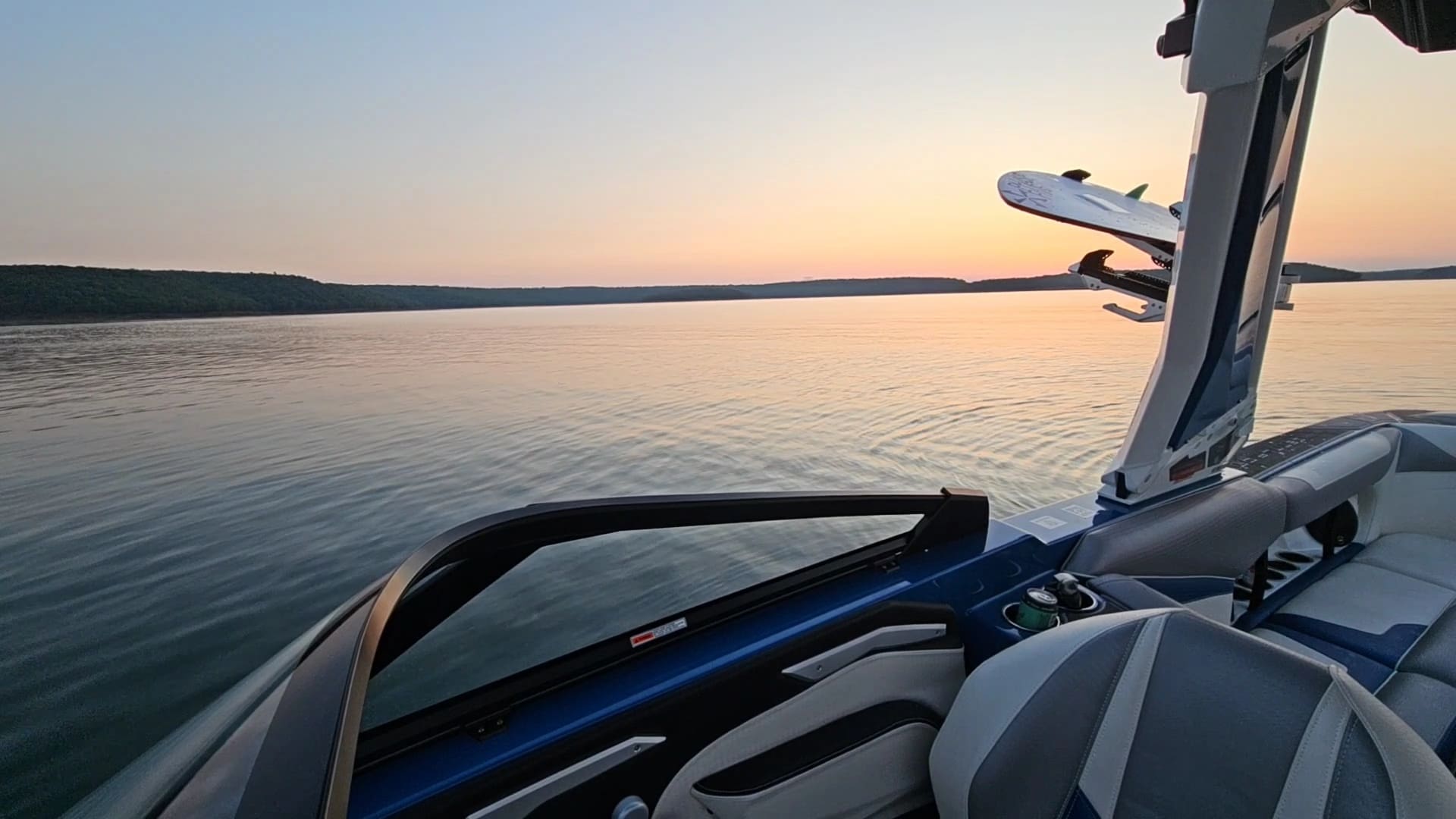 A boat is in the water at sunset.